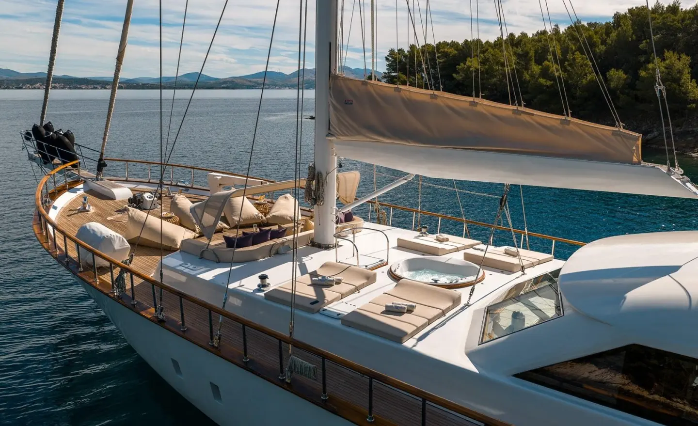 Luxurious sailing yacht deck with seating area at sunset on the open sea