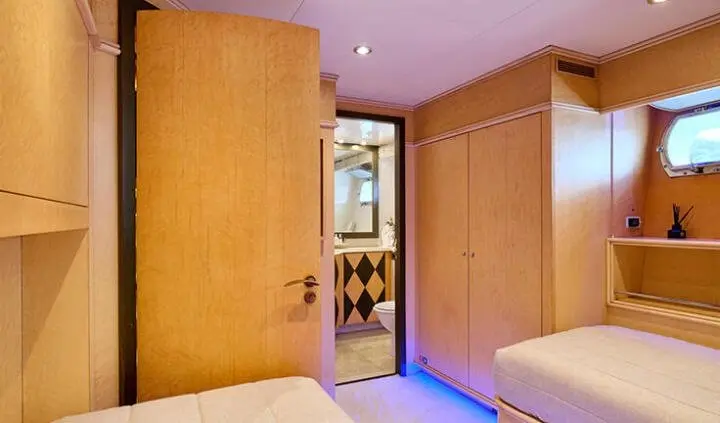 Mobius cabin twin beds with ensuite; wood-paneled walls and doorway view