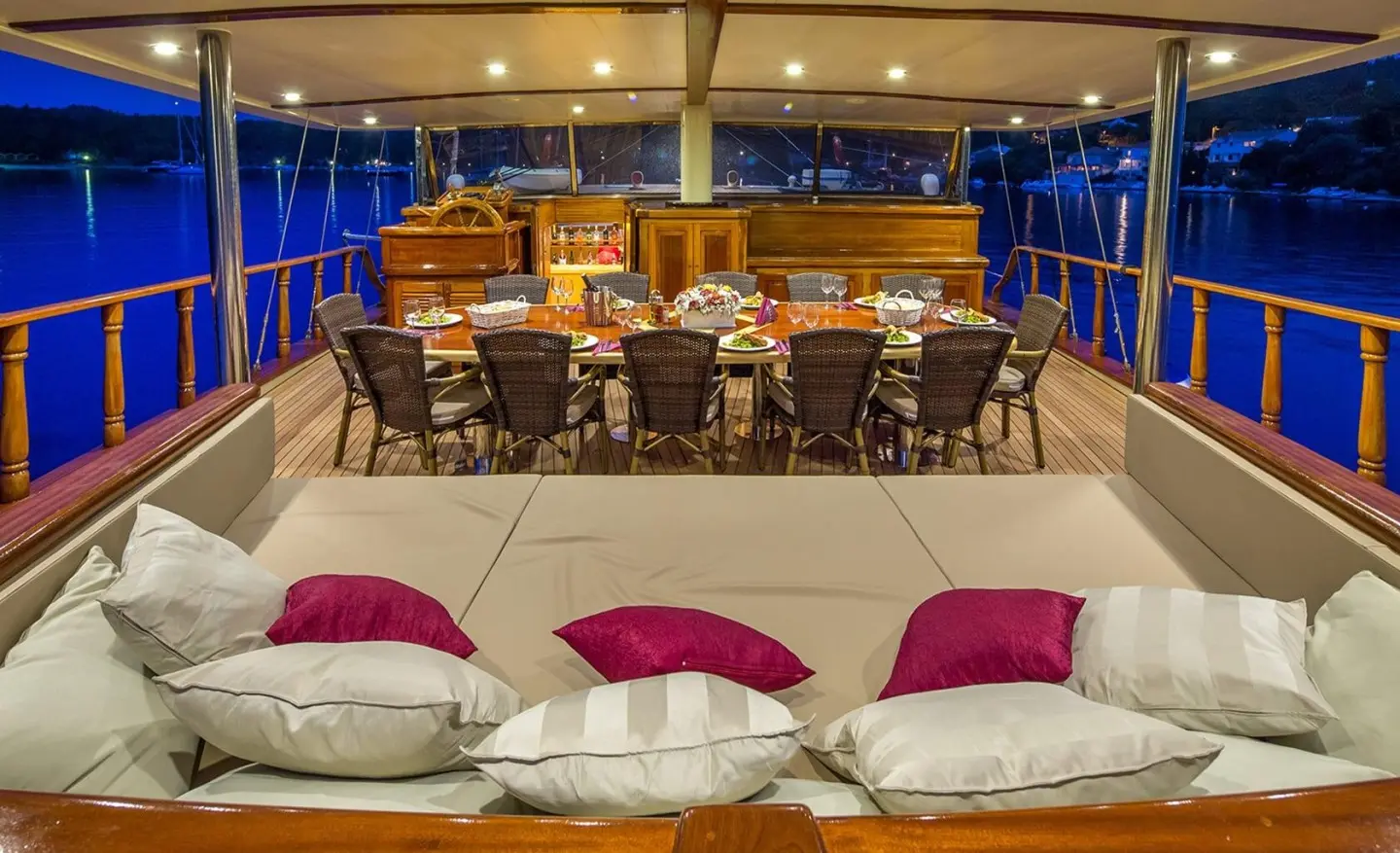 Gulet Morning Star aft deck with seating, cushions, and dining table inside lights