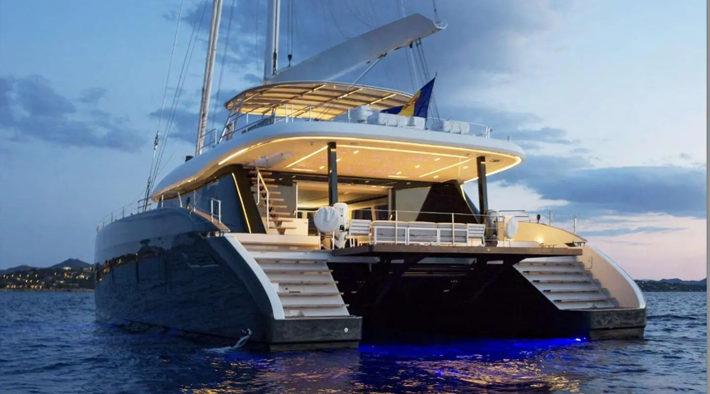 Above & Beyond luxury yacht anchored at sunset with twin stern stairs