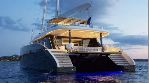 Above & Beyond luxury yacht anchored at sunset with twin stern stairs