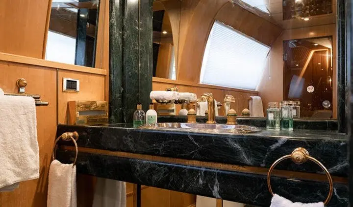 View of a yacht master cabin with a large king bed and wood paneling