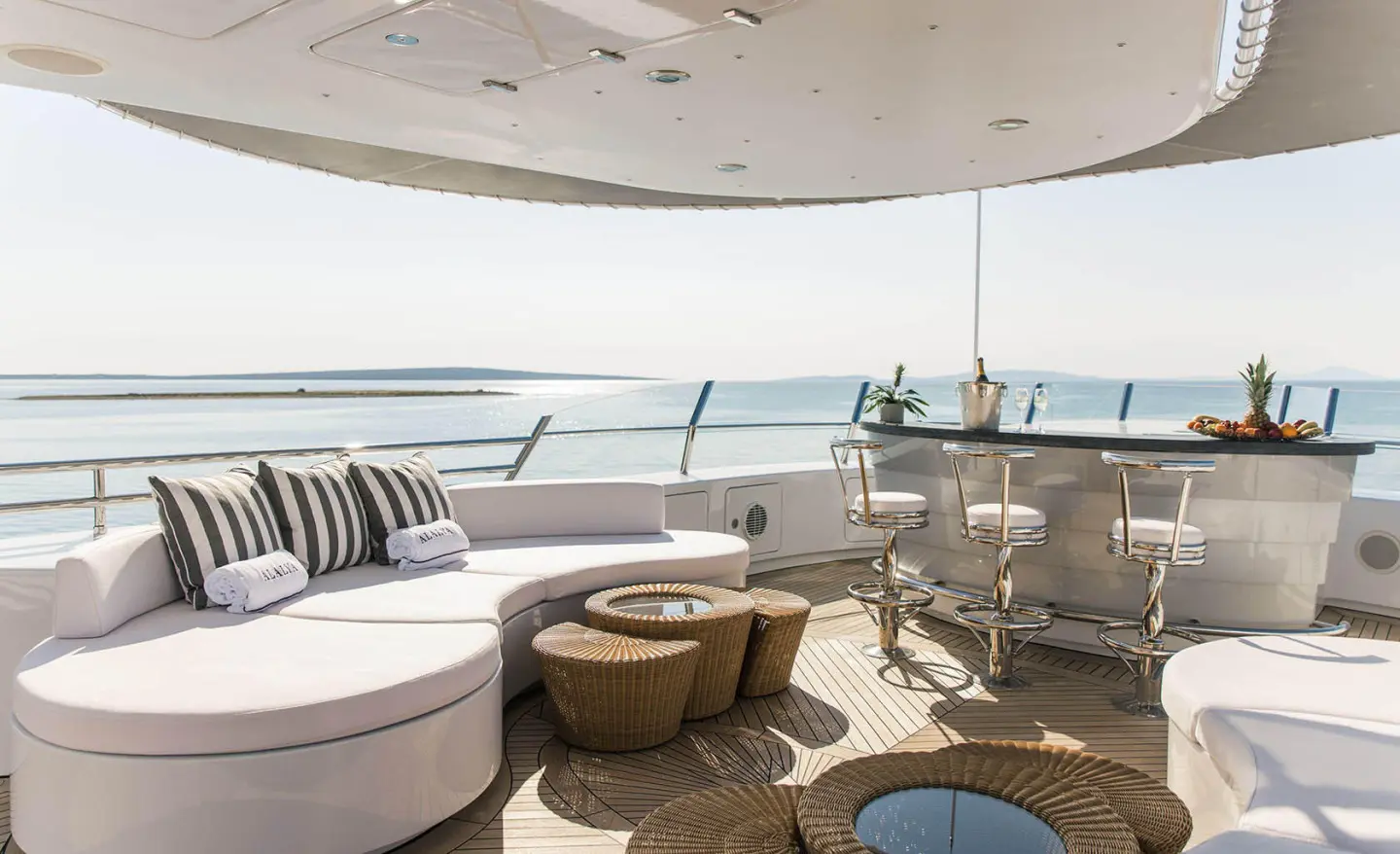Alalya yacht deck seating area with round coffee table and ocean view