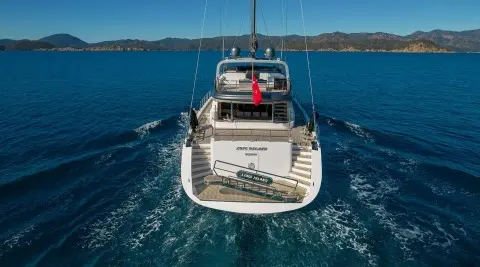 Aerial view of a luxury yacht named Long Island anchored in blue water at sunset