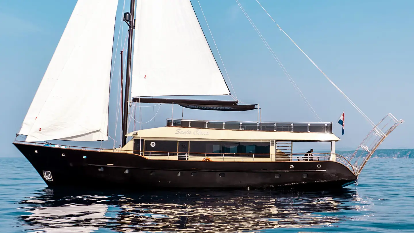 Luxury sailing yacht Santa Clara moored, side view with sails folded