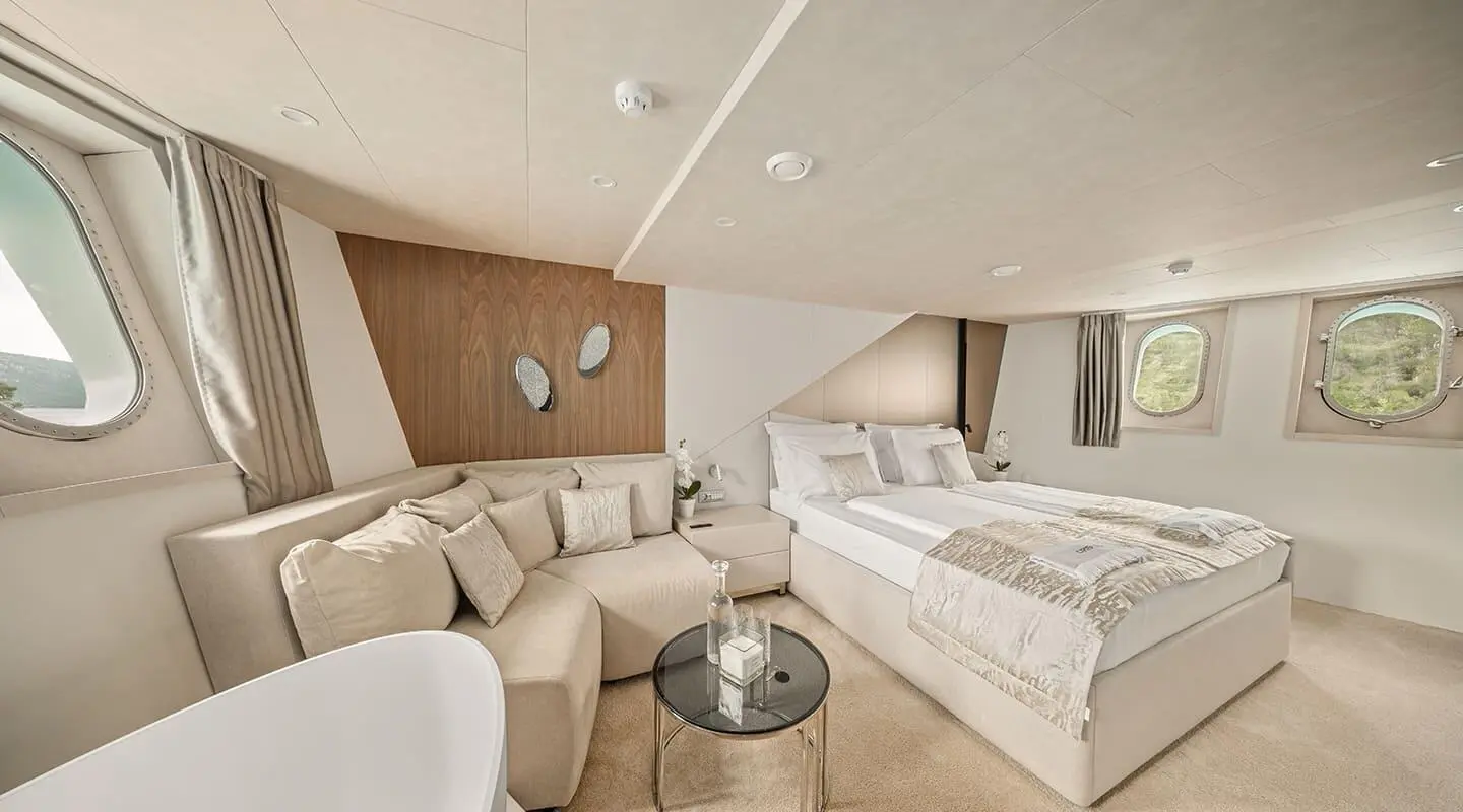 Luxurious yacht Cristal master cabin with beige seating and bed
