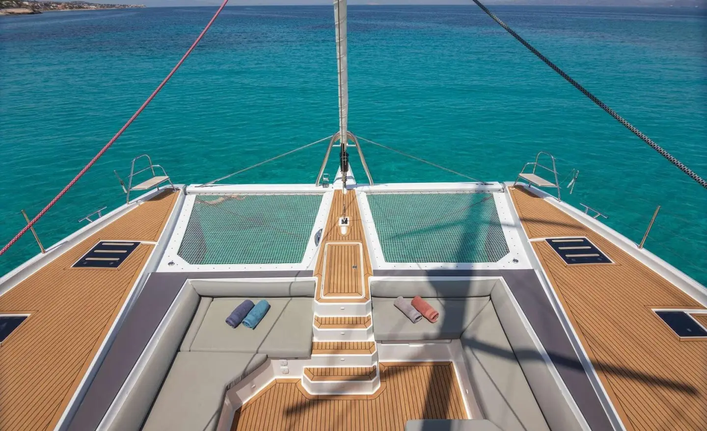 Astoria yacht deck stairs leading to railing with calm blue sea backdrop