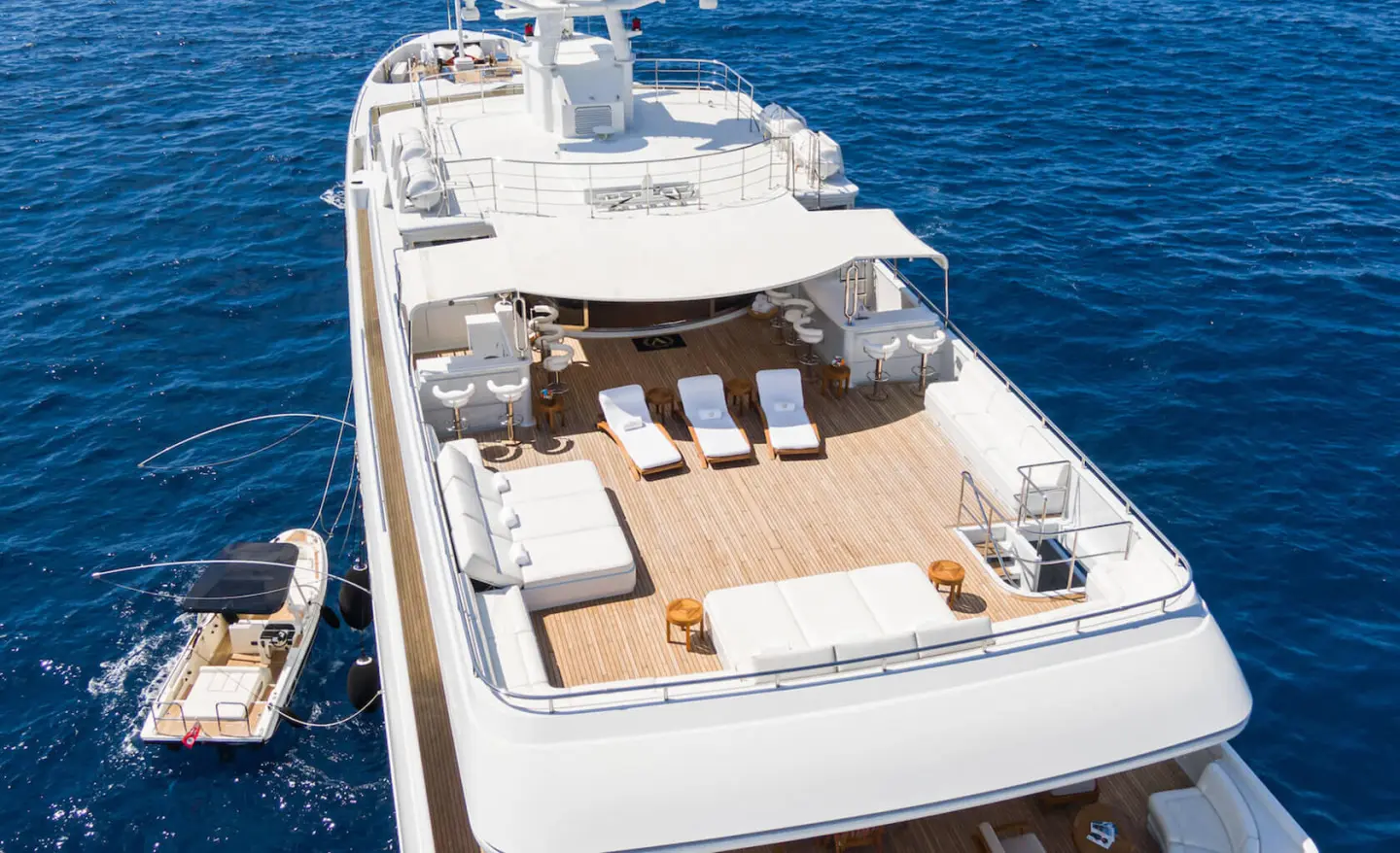 Overhead view of Apogee yacht deck with sun loungers and seating on blue sea
