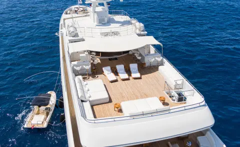 Overhead view of Apogee yacht deck with sun loungers and seating on blue sea