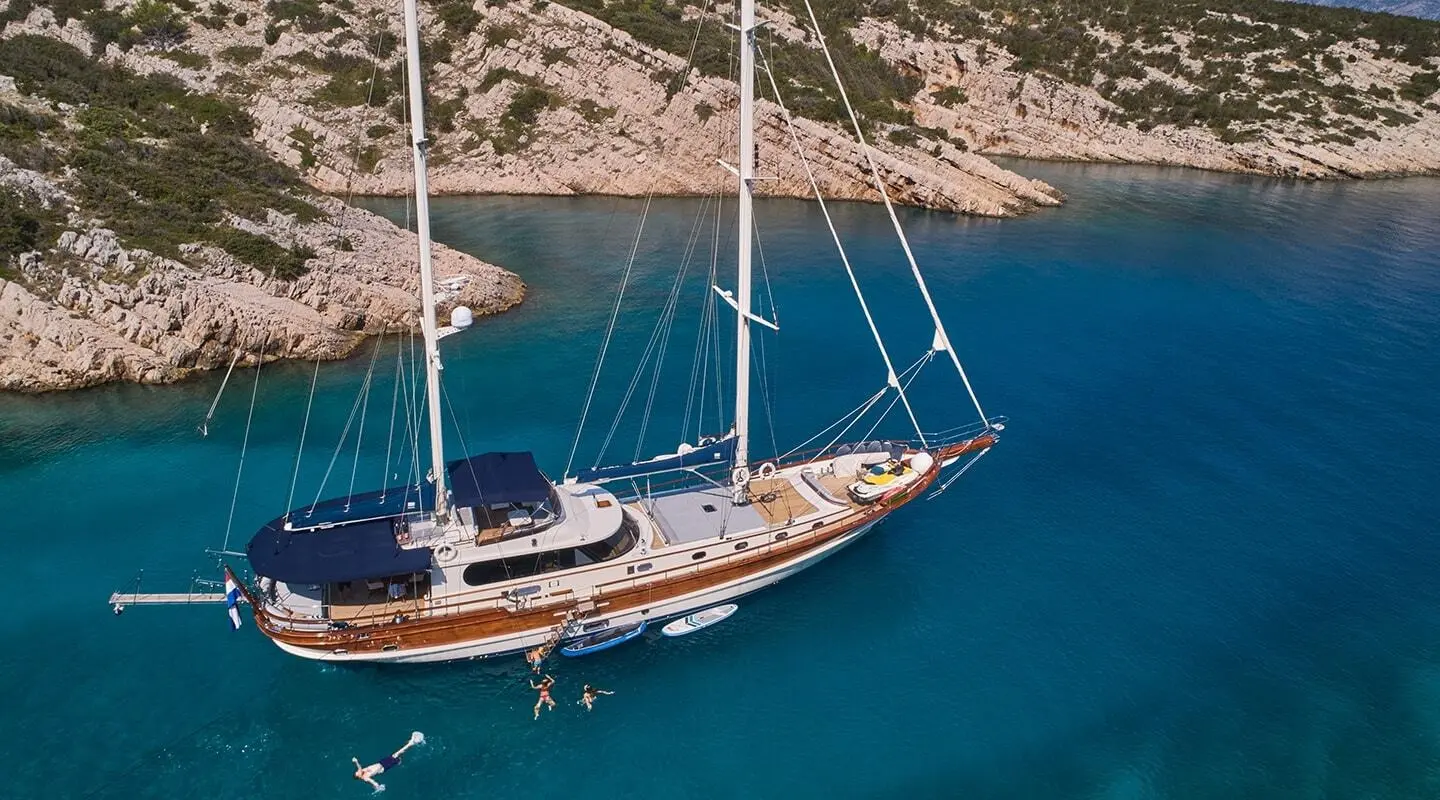 Lotus luxury gulet sailing at sunset, calm turquoise sea and coastline