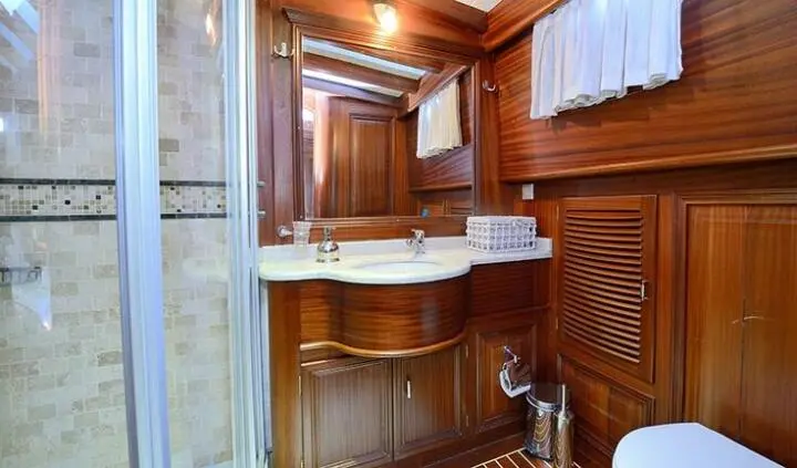 Samarkand yacht cabin with wooden walls, king bed, and ensuite bathroom