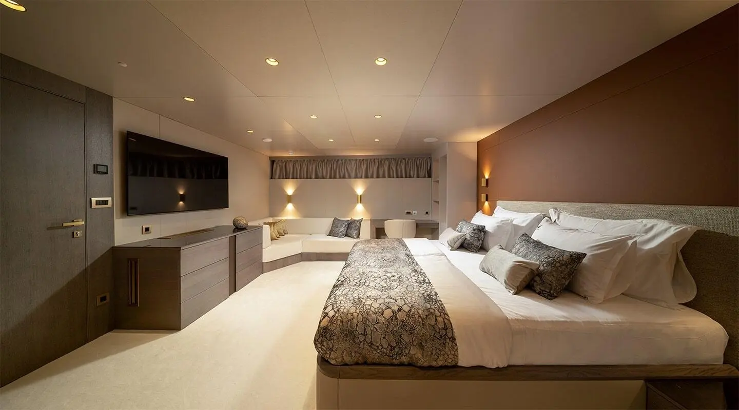 Nocturno yacht interior bedroom with two beds, warm lighting, and neutral decor