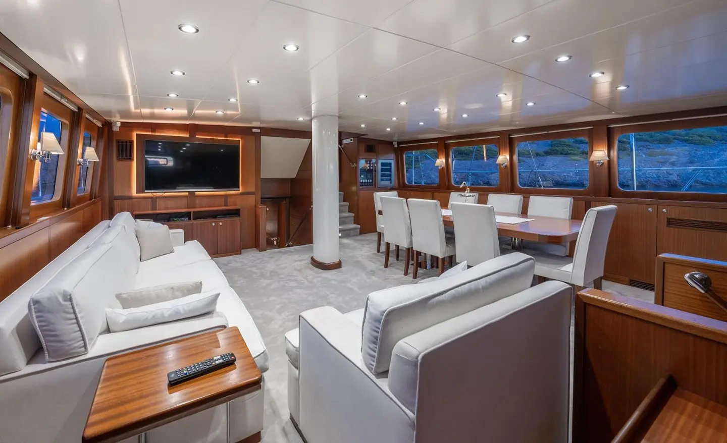 Lucky You yacht interior on deck with seating, cushions, and warm lighting at sunset