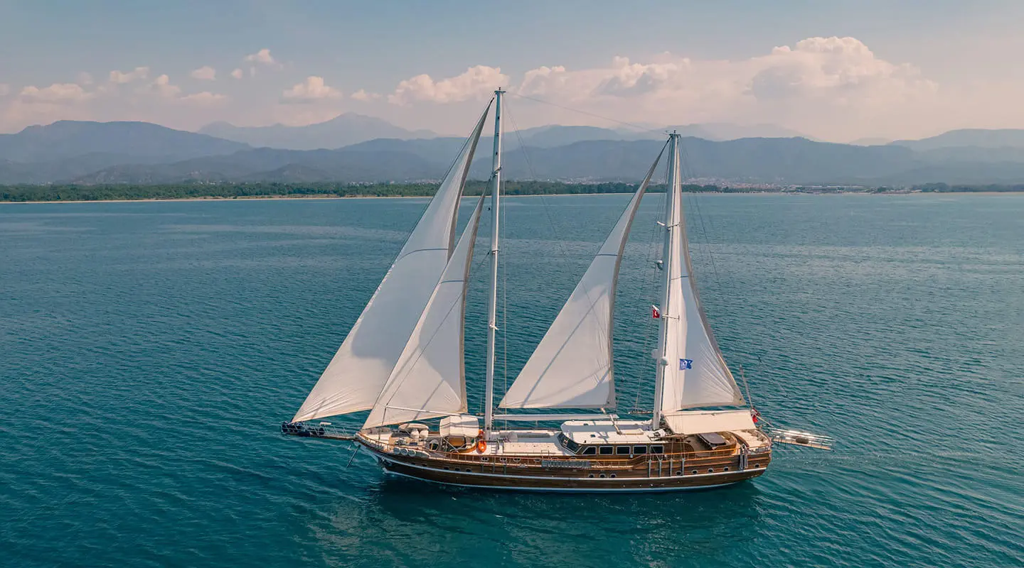 Lycian Queen luxury gulet sailing at sunset with white sails on blue sea