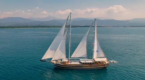 Lycian Queen luxury gulet sailing at sunset with white sails on blue sea