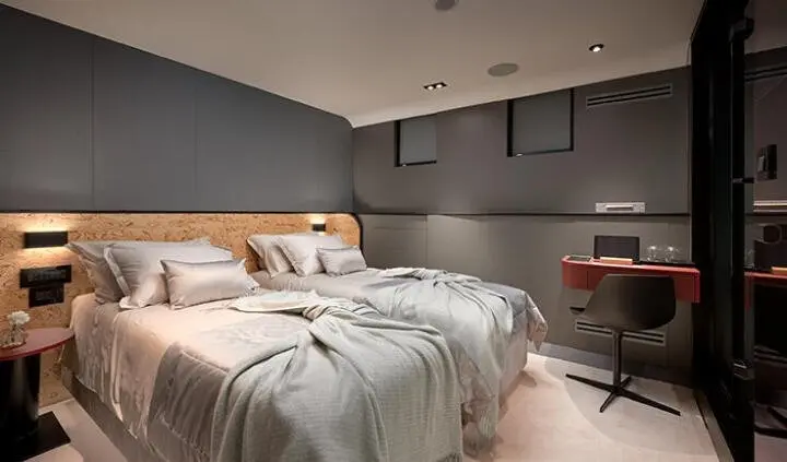 Anetta cabin with a king bed, gray walls, and bedside lamps