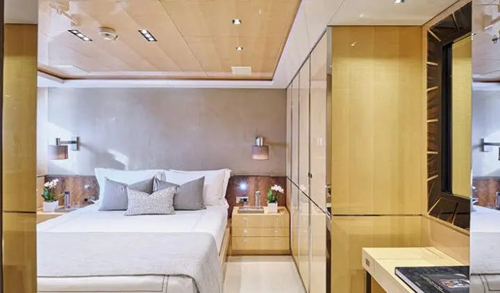 Master cabin with king bed, bedside tables, and ensuite doorway visible