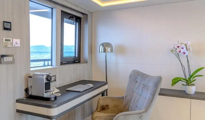 Master cabin aboard Freedom yacht with king bed, ensuite seen near window