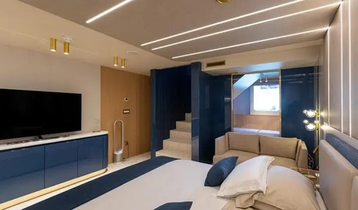 Master cabin on Scorpios yacht with king bed, ensuite area and modern decor