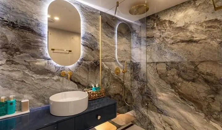 Bathroom on Scorpios cabin: stone walls, shower area, sink and mirror