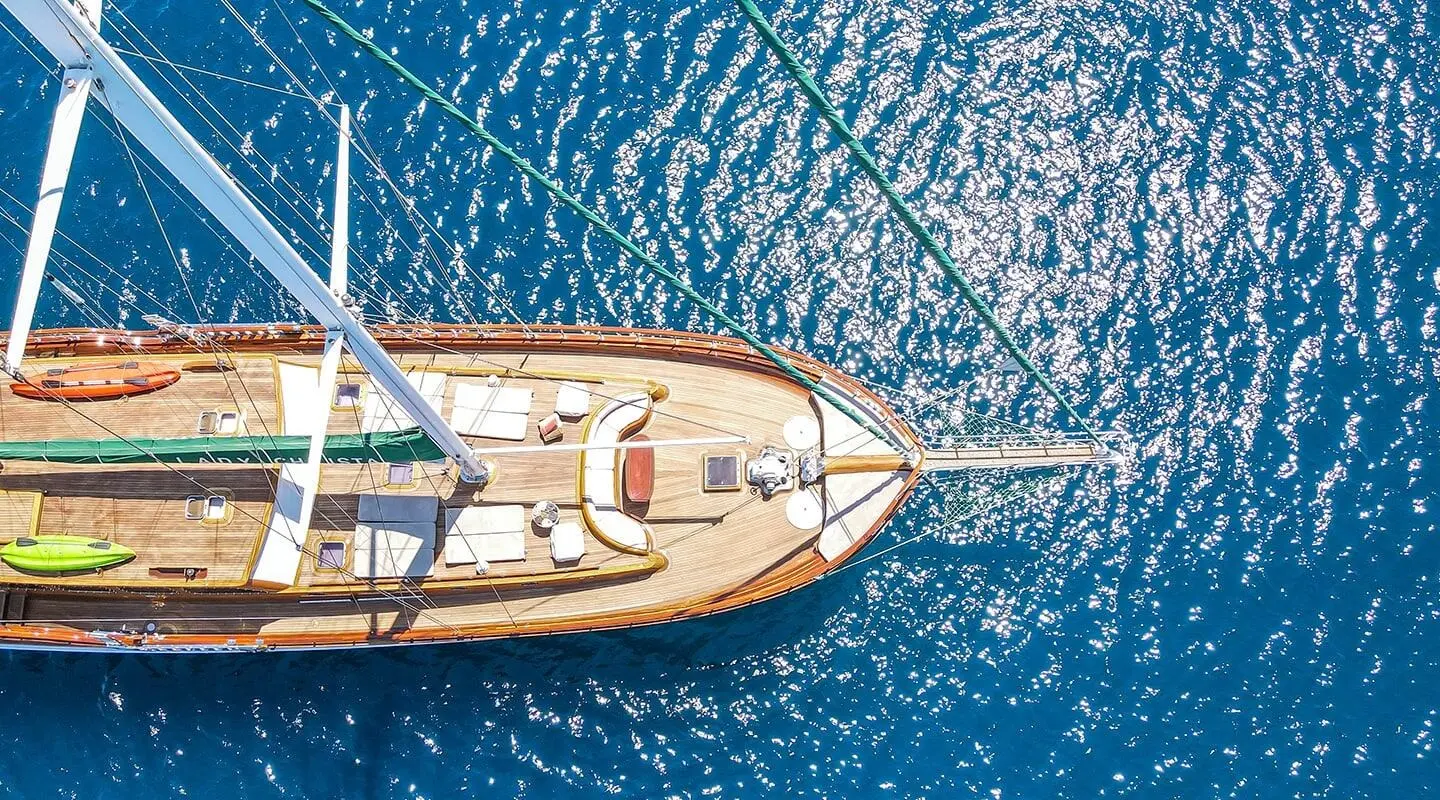 Lady Christa yacht docked at sunset with a wooden deck and blue sea