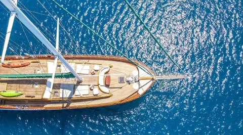 Lady Christa yacht docked at sunset with a wooden deck and blue sea