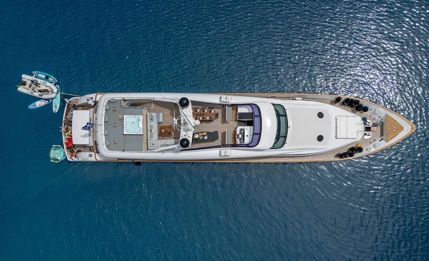 Pareaki II motor yacht anchored in calm blue water, sunlit deck view