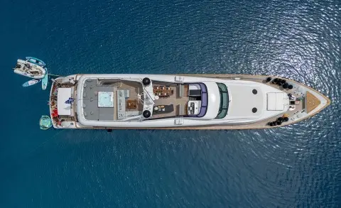 Pareaki II motor yacht anchored in calm blue water, sunlit deck view