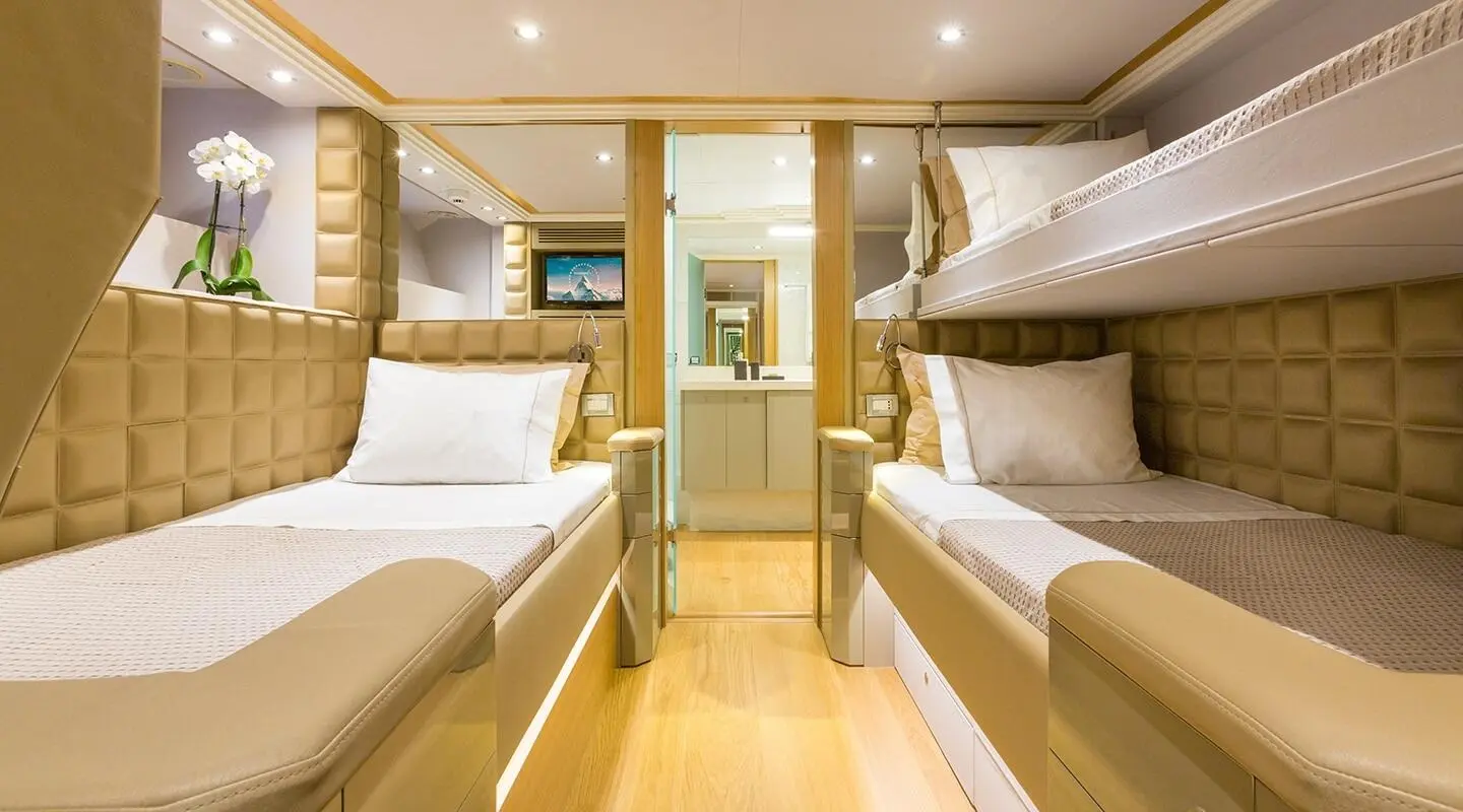 Aquarella yacht twin cabin interior with two single beds and wood accents