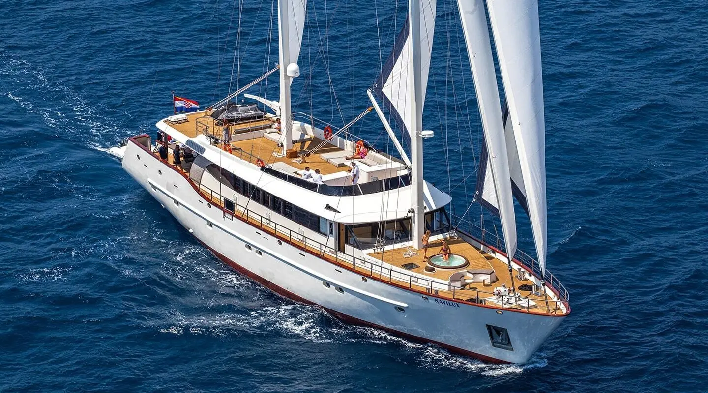 Navilux yacht on blue sea with open deck and sails visible