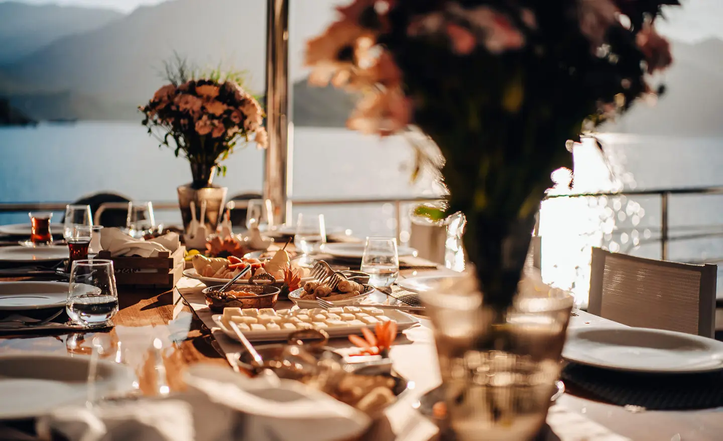 Queen Of Makri yacht anchored at sunset with elegant table set aboard