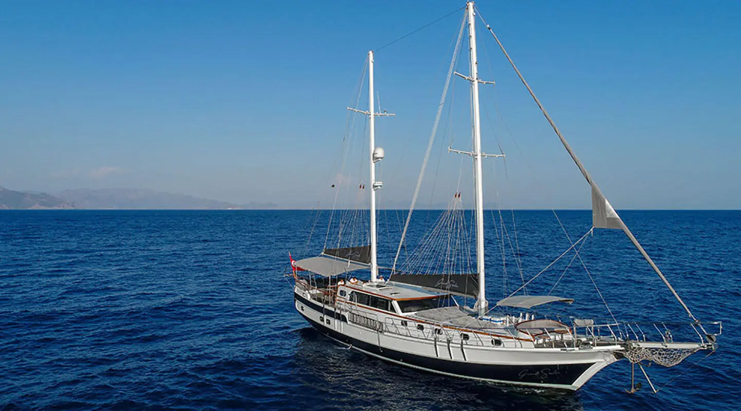 Sailing yacht Grand Sailor on the open sea at sunset, side view