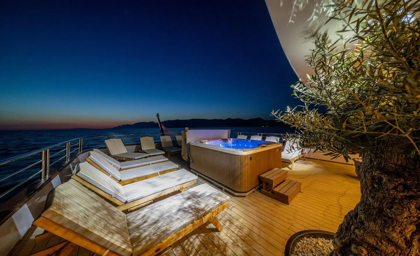 Olimp motor yacht at sunset with wooden deck and seating area