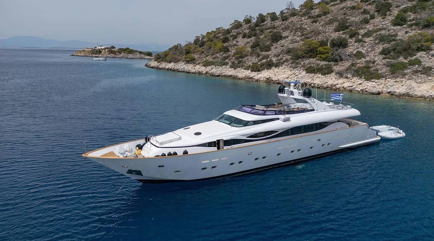 Pareaki II yacht anchored near rocky shoreline with clear blue water