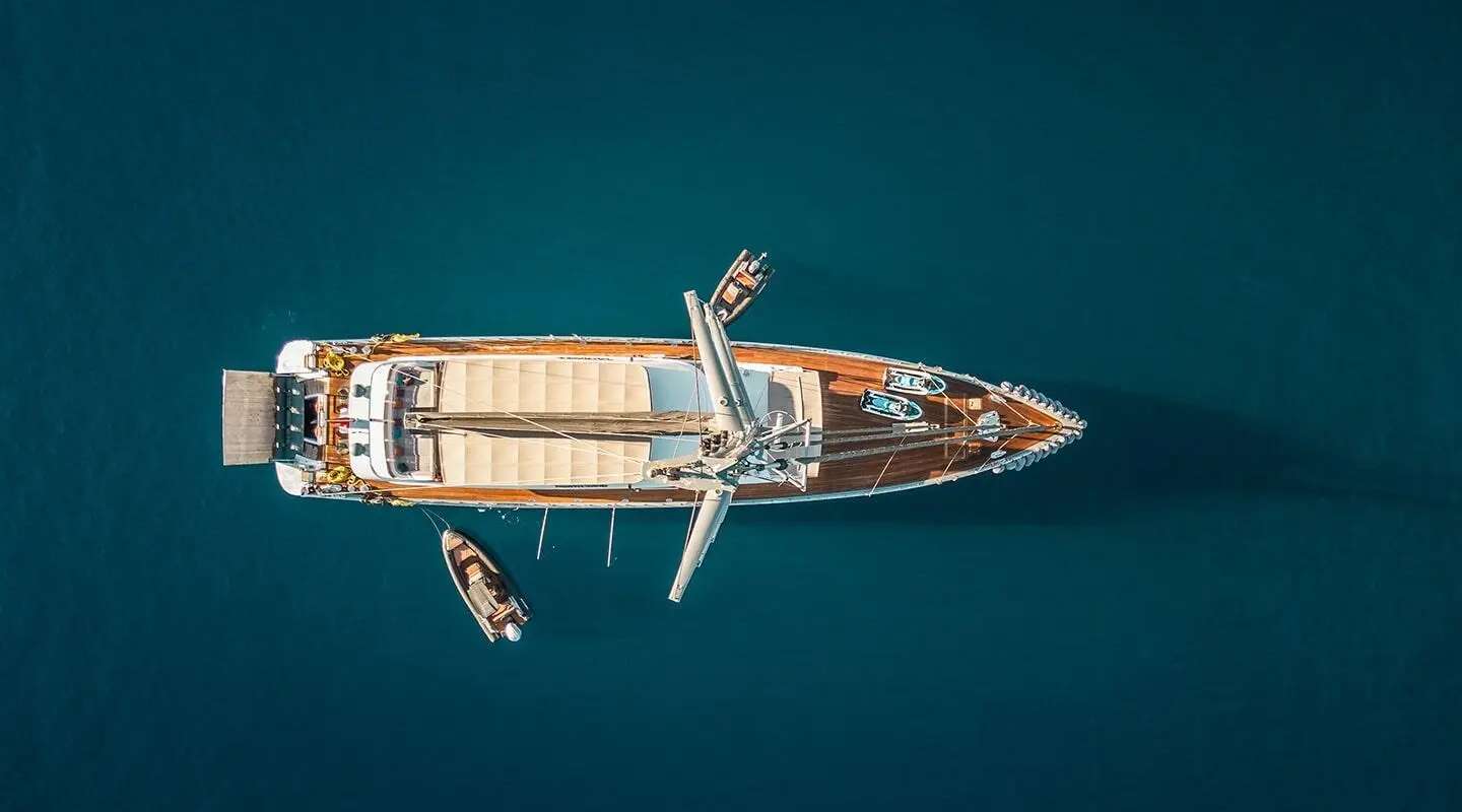 Aerial view of North Wind yacht anchored in clear blue sea, white hull