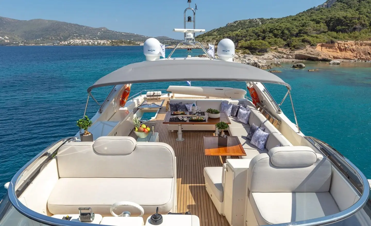 Divine yacht deck underway with seating, helm, and open waters behind