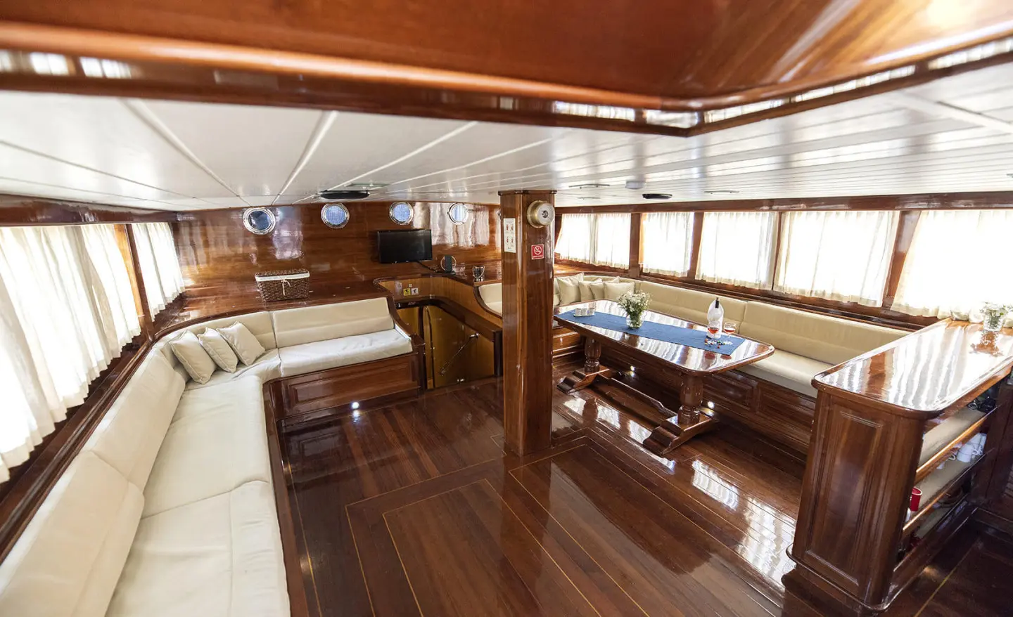 Kayhan 8 yacht interior with polished wooden deck, stairs, and seating