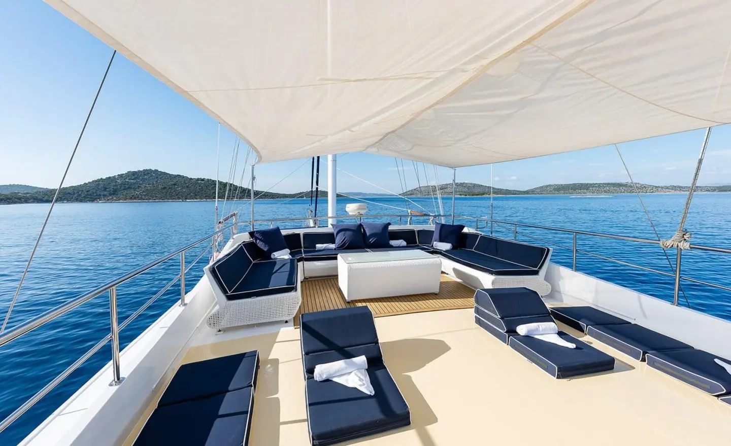 Aurum gulet yacht sun deck with blue cushioned seating and canopy overhead