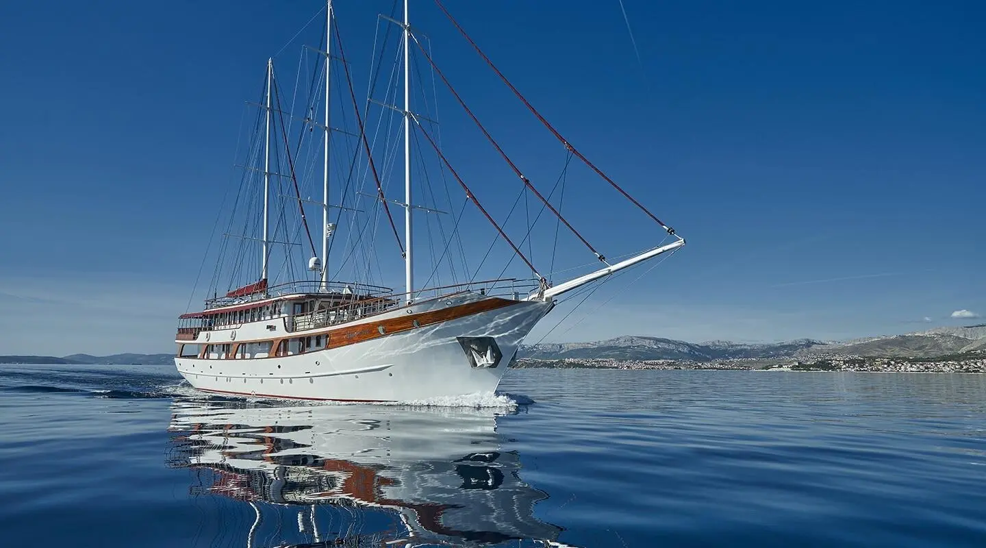 Amorena motor yacht anchored on calm blue sea with clear sky