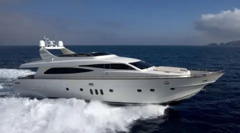 White motor yacht Miraval cruising fast on open sea