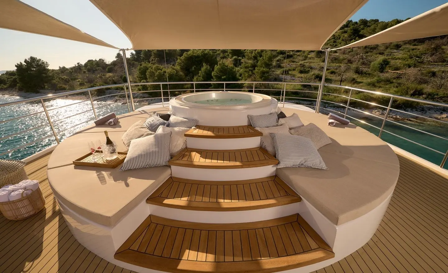 Aerial view of Bellezza yacht deck with steps, seating, and wooden flooring