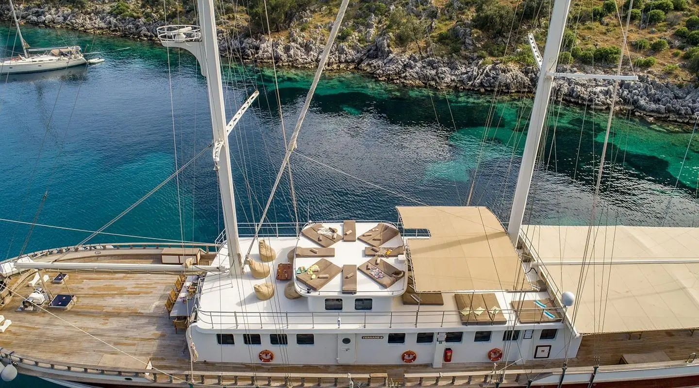 Tersane 8 yacht seen from above with wooden deck and seating at sunset