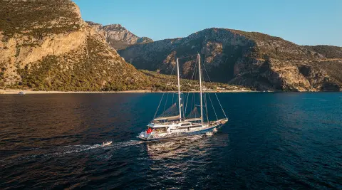 Esma Sultan luxury gulet anchored at sunset with sails down and calm blue water