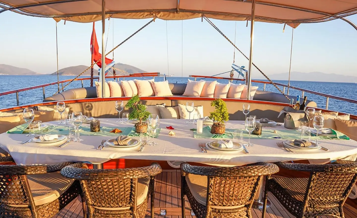 La Bella Vita yacht deck seating at sunset with cushions and ocean view