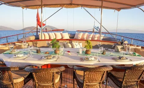 La Bella Vita yacht deck seating at sunset with cushions and ocean view