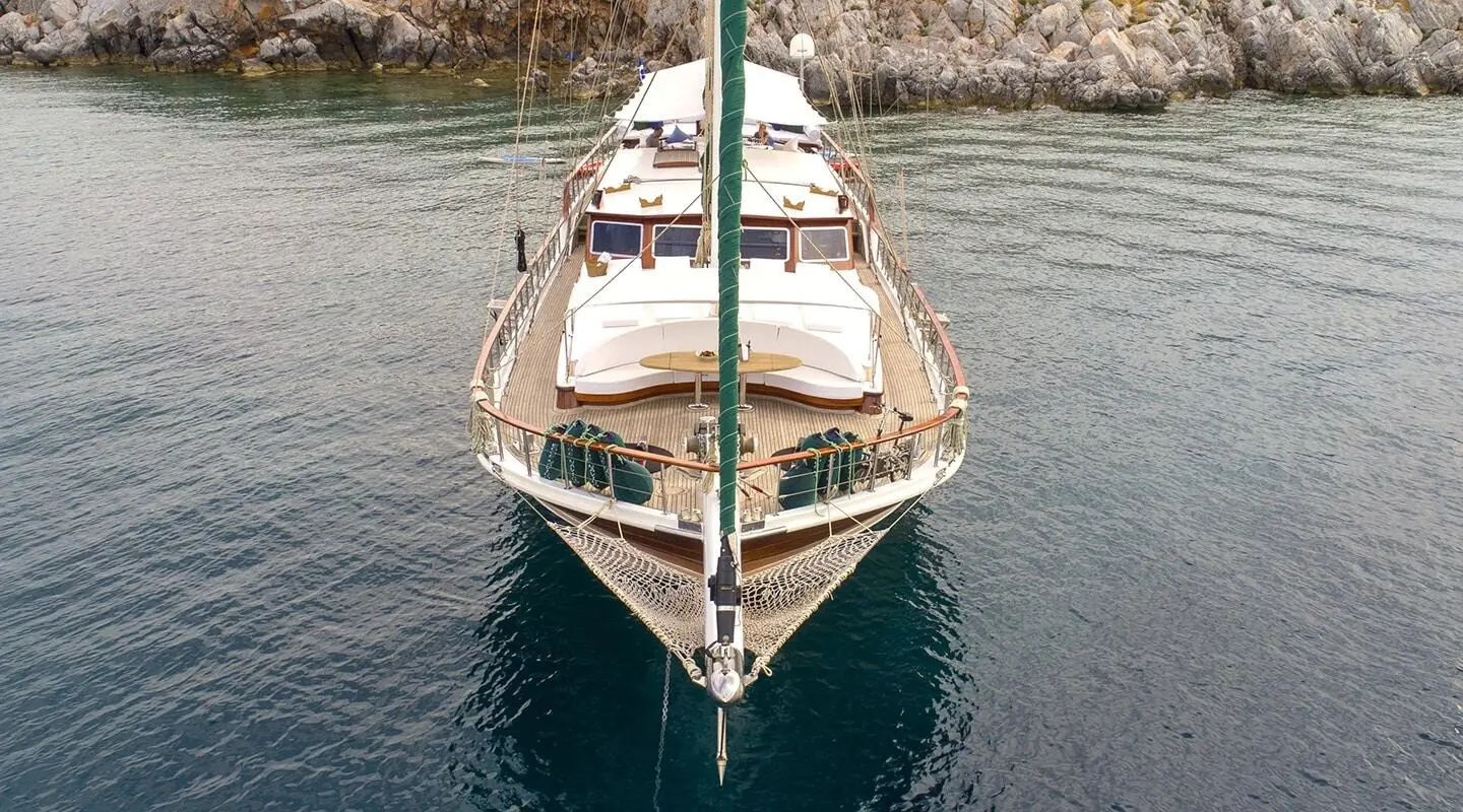 Gulet Ecce Navigo anchored in calm blue water, bow facing viewer