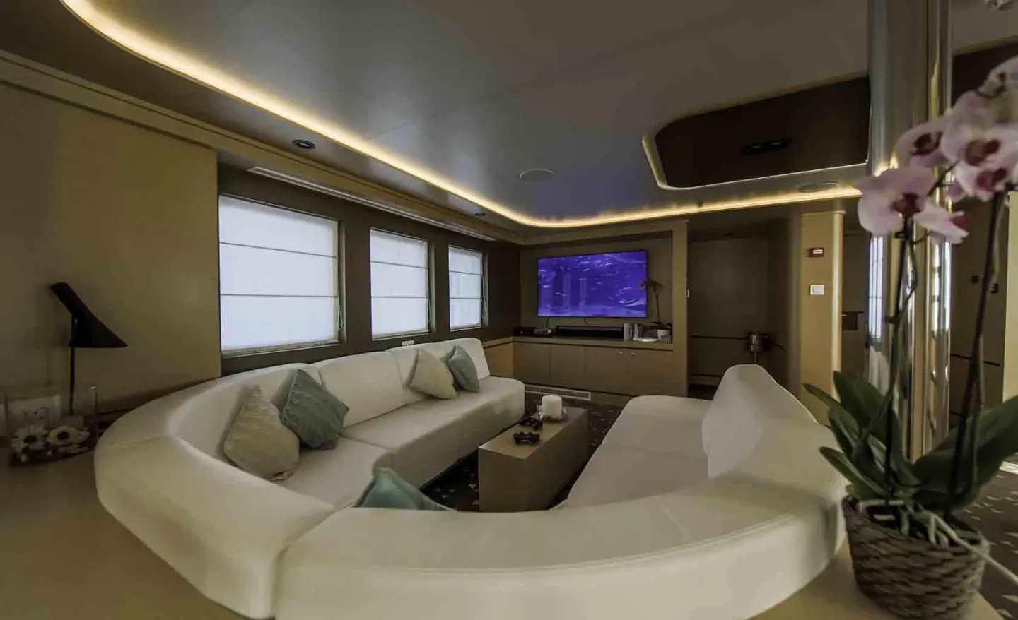 Luxurious yacht Omnia interior with curved white seating and large windows