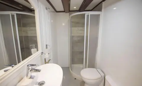 Grande Mare yacht bathroom interior with curved shower enclosure and white fixtures