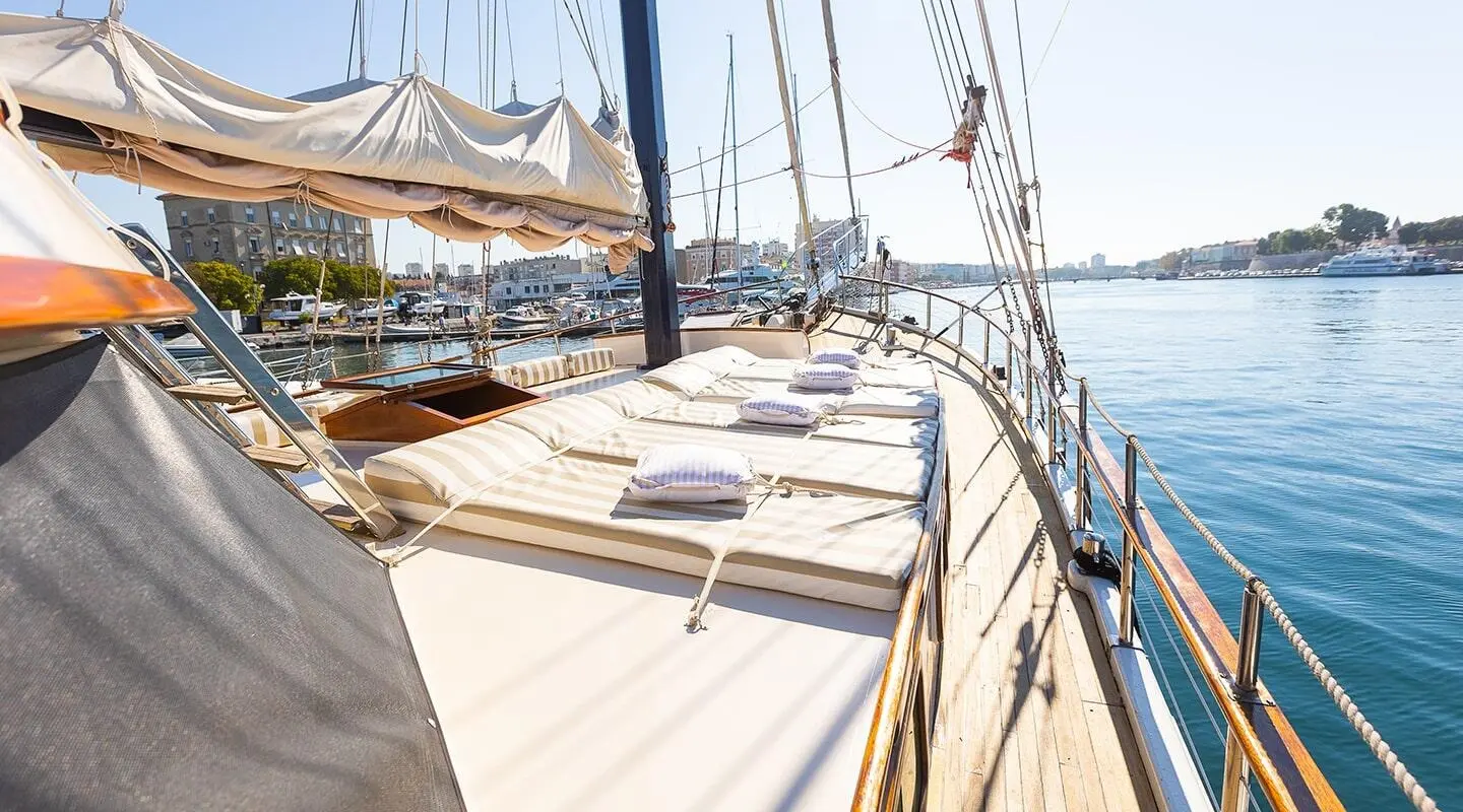 Gardelin yacht deck view with sails at sunset, rope lines and calm sea