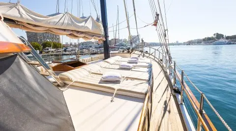 Gardelin yacht deck view with sails at sunset, rope lines and calm sea
